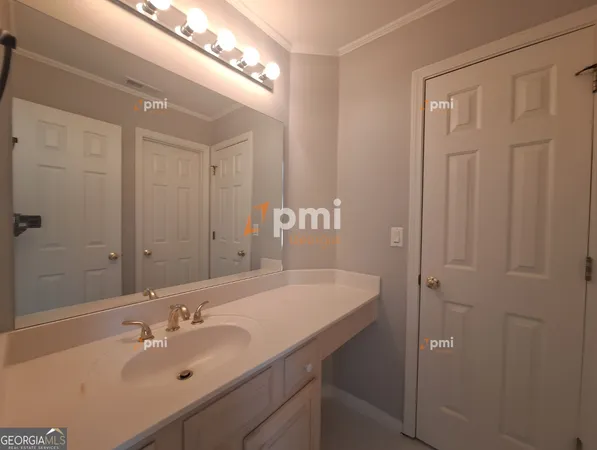 a bathroom with a sink double vanity and a mirror