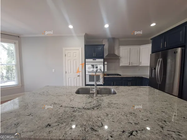 a kitchen with stainless steel appliances a refrigerator stove microwave and cabinets