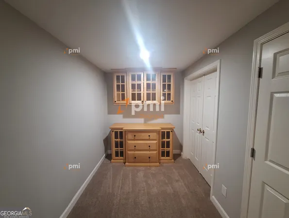 a view of a bedroom with furniture and window