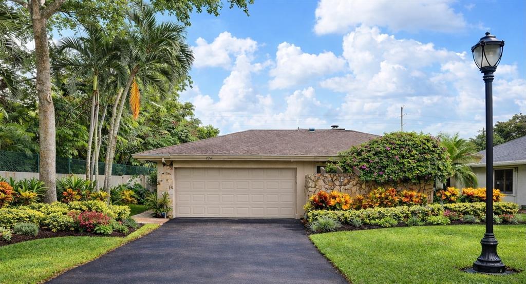 a front view of a house with a garden and plants