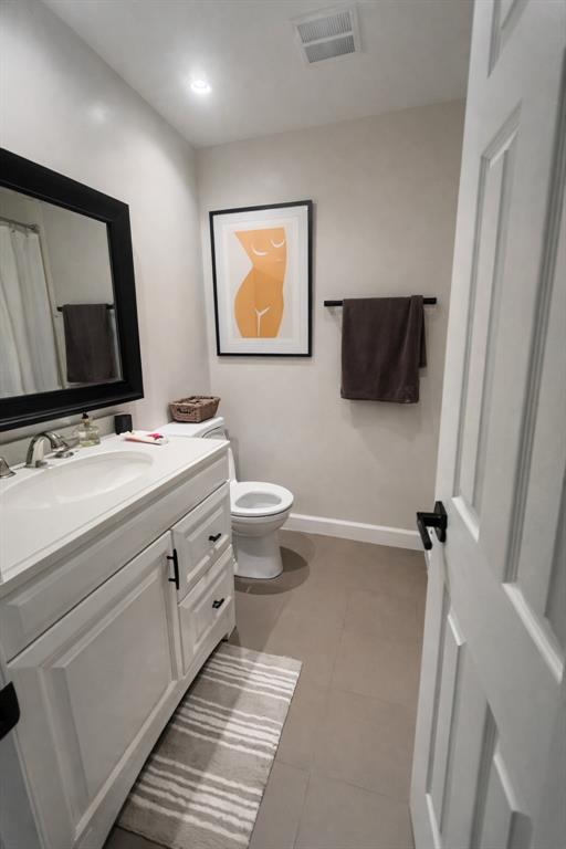 126 Laurel Road Hollywood, FL 33021 - Photo 12 of 16 a bathroom with a toilet sink and mirror