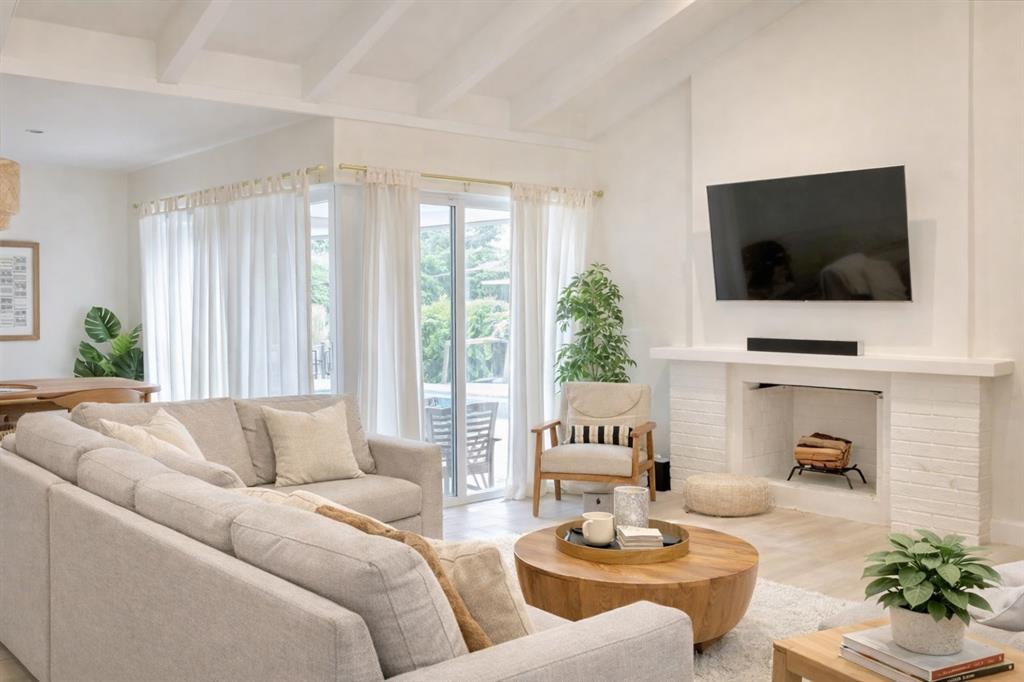 126 Laurel Road Hollywood, FL 33021 - Photo 2 of 16 a living room with furniture and a flat screen tv