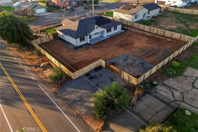 an aerial view of a house with a yard