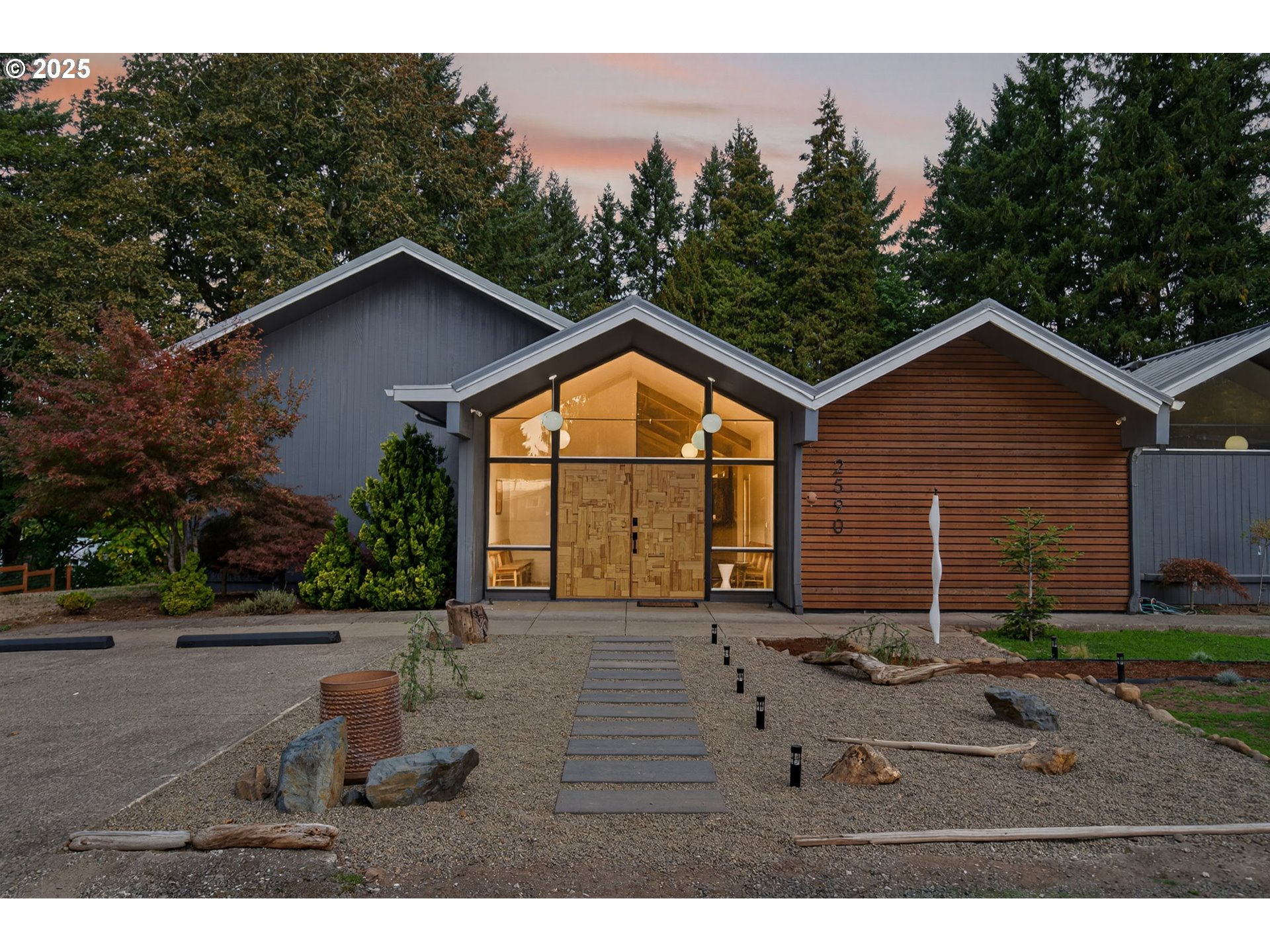 a backyard of a house with wooden floor and outdoor seating