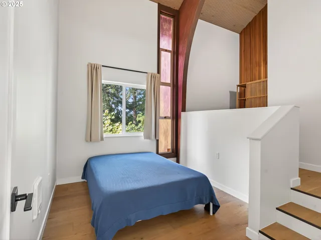 a bedroom with a bed and a window