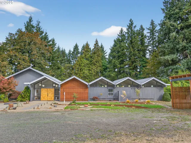 a house view with wooden fence and trees