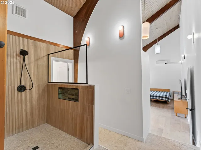 a bathroom with a shower and mirror
