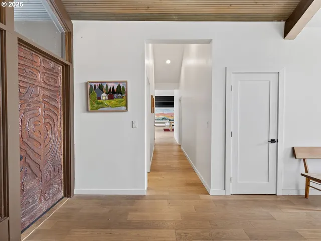 a view of a hallway with wooden floor