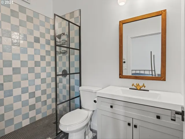 a bathroom with a sink a toilet and shower curtain