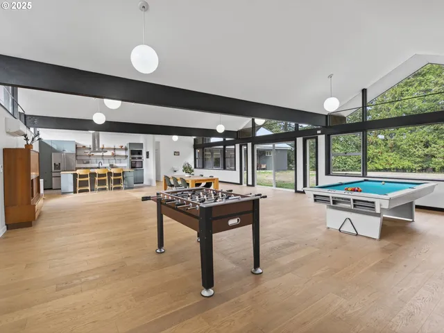 a living room with furniture a table and a large window
