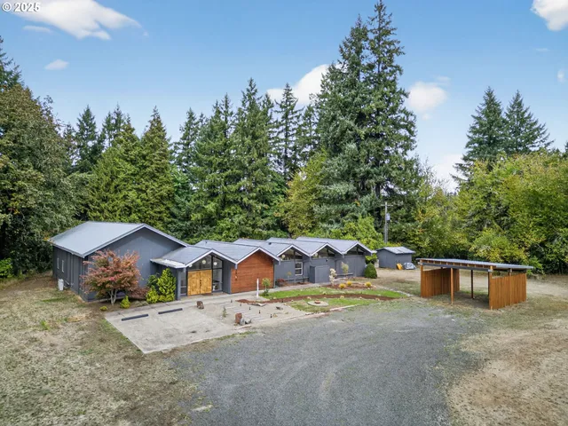 a view of house with yard and a garden