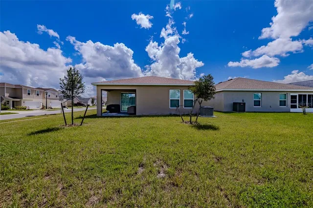 a house view with swimming pool and garden space