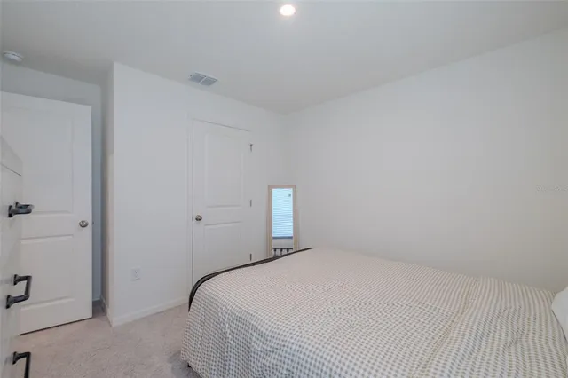 a bedroom with a bed and a night stand