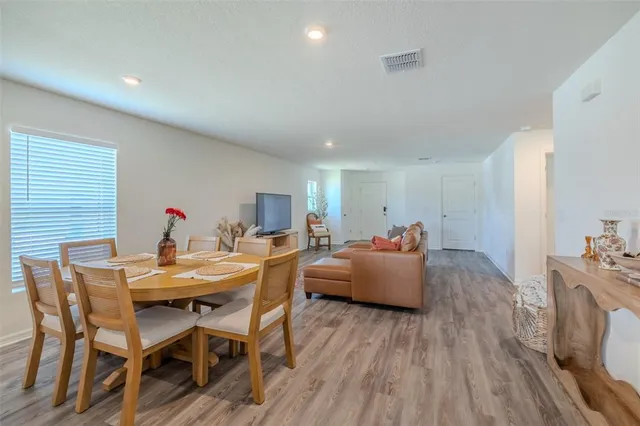 a view of a dining room with furniture and wooden floor