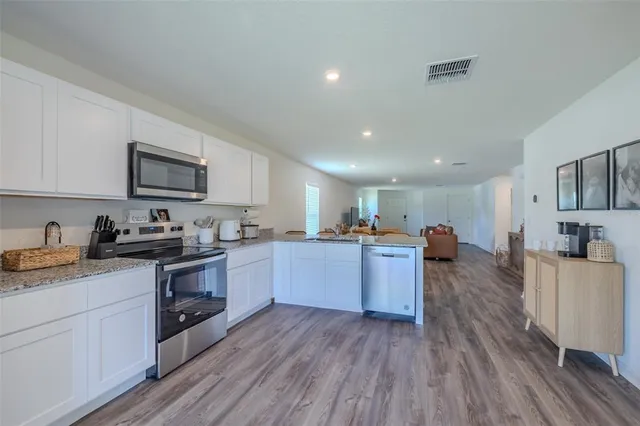 a kitchen with sink a stove and cabinets