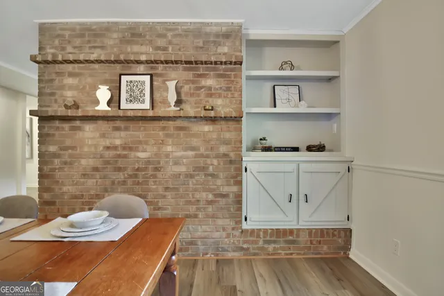 a view of a room with wooden floor and a potted plant
