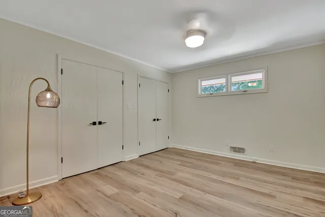 a balcony with wooden floor table and chairs