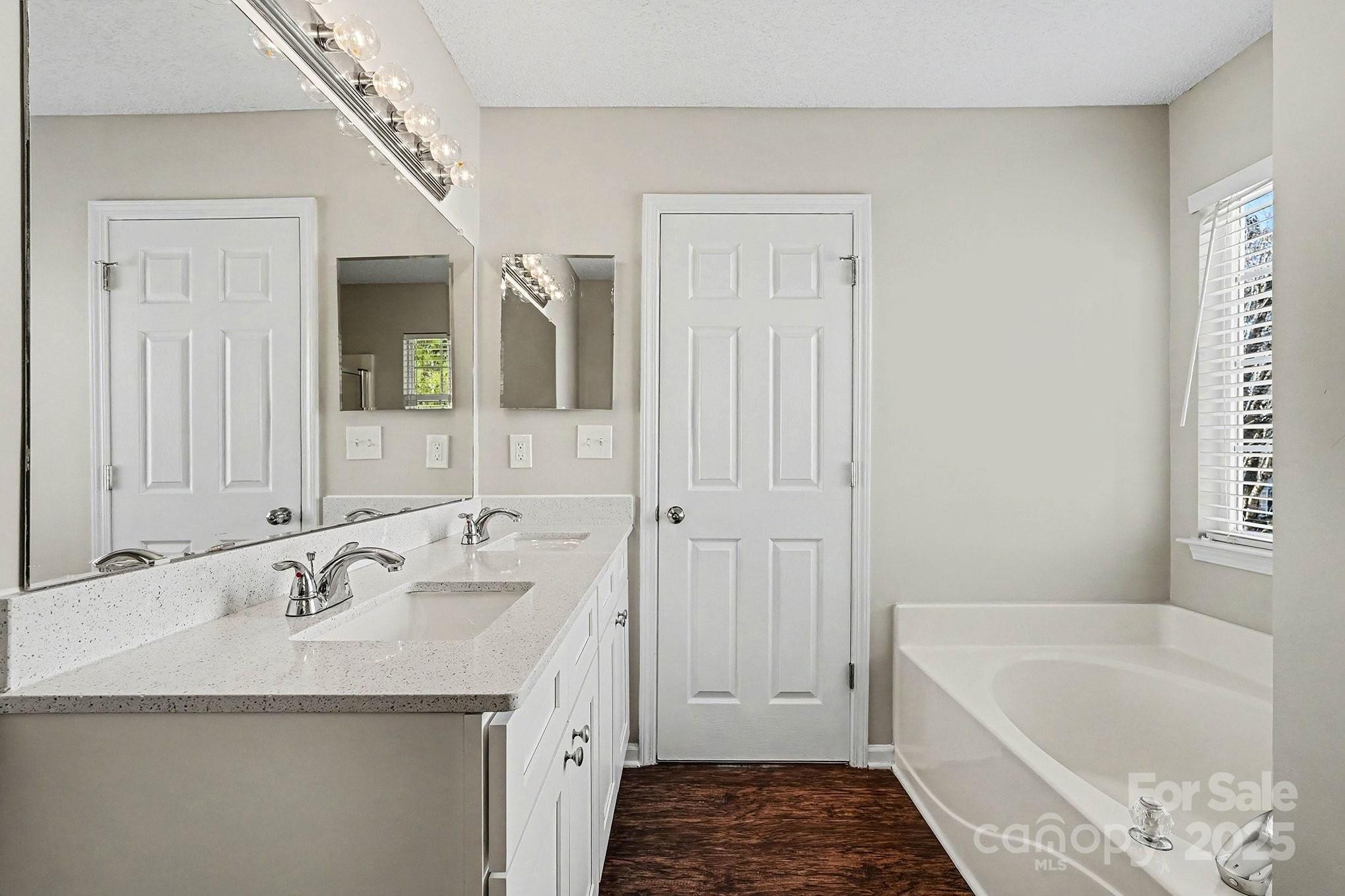1655 Summit Ridge Lane Kannapolis, NC 28083 - Photo 11 of 17 a bathroom with a tub sink and mirror
