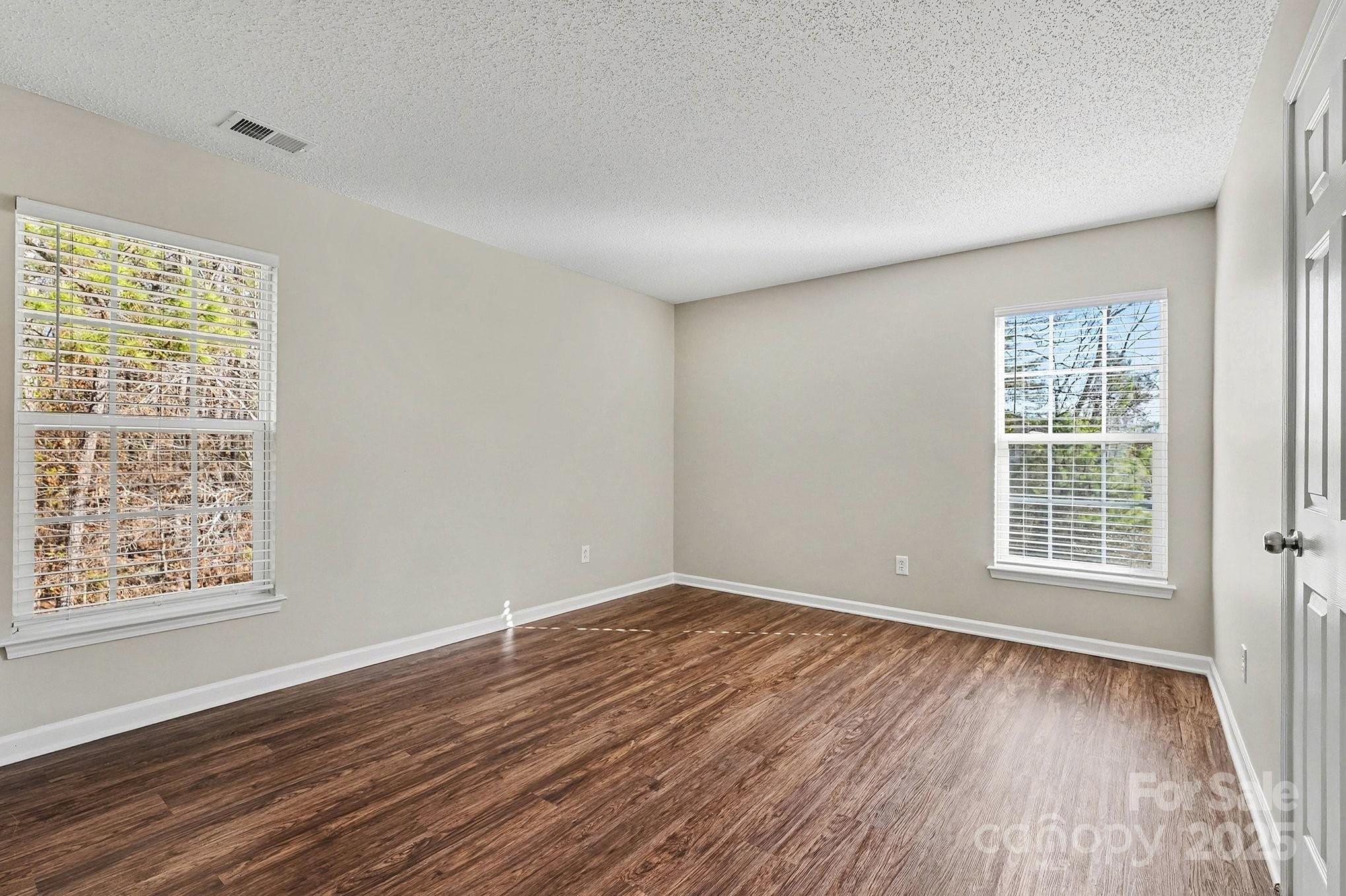 1655 Summit Ridge Lane Kannapolis, NC 28083 - Photo 12 of 17 an empty room with wooden floor and windows