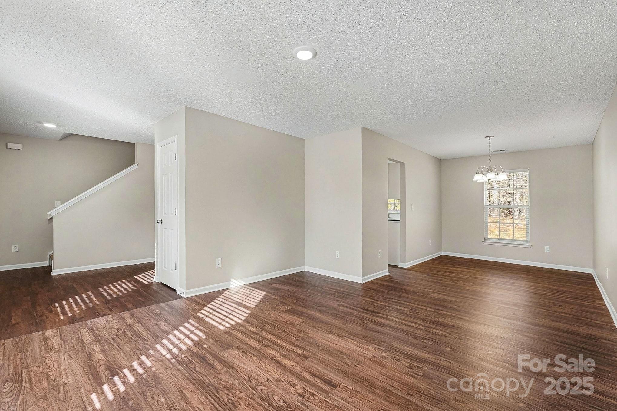 1655 Summit Ridge Lane Kannapolis, NC 28083 - Photo 5 of 17 a view of an empty room and window and wooden floor