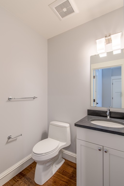 17 Abbey Road, Unit 17 South Walpole, MA 02071 - Photo 4 of 6 a bathroom with a granite countertop sink a toilet and a mirror