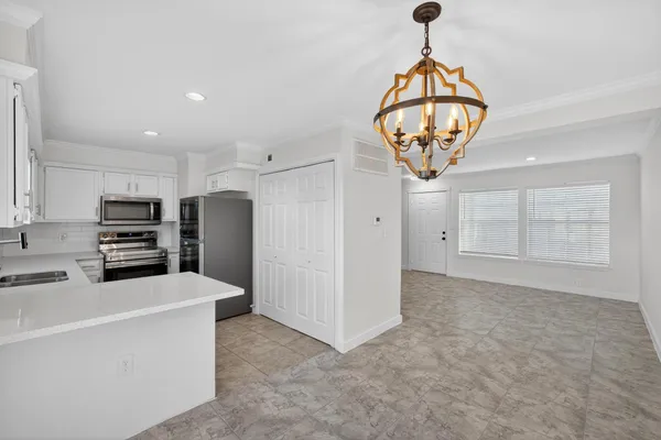 a kitchen with stainless steel appliances a refrigerator sink and cabinets