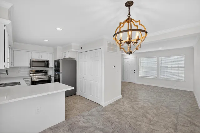 a kitchen with stainless steel appliances a refrigerator sink and cabinets