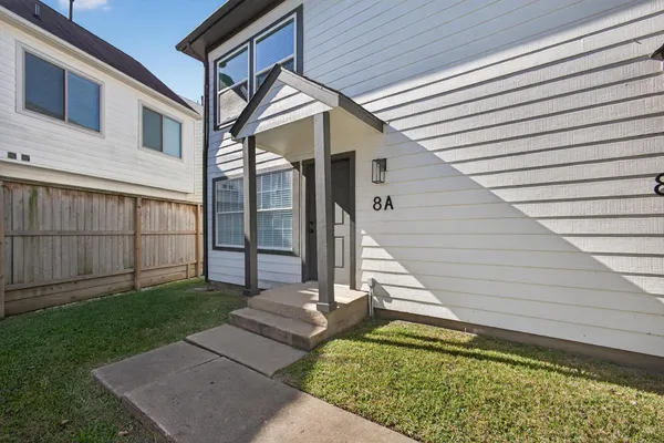 a view of backyard with large tree