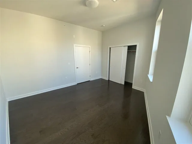 an empty room with wooden floor