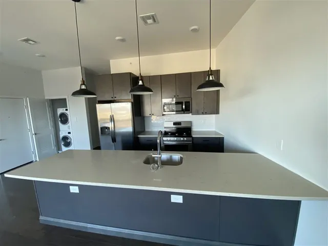 a view of a kitchen with stainless steel appliances
