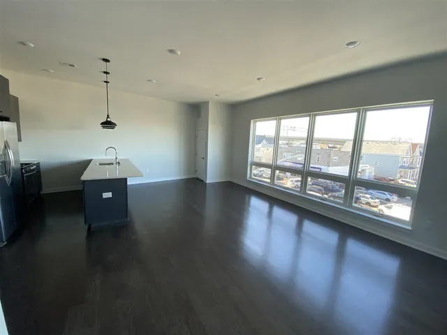 a room with hard wood floor and window
