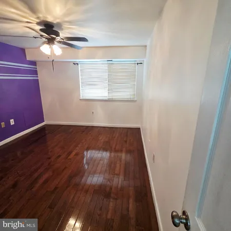 a view of a room with wooden floor and window