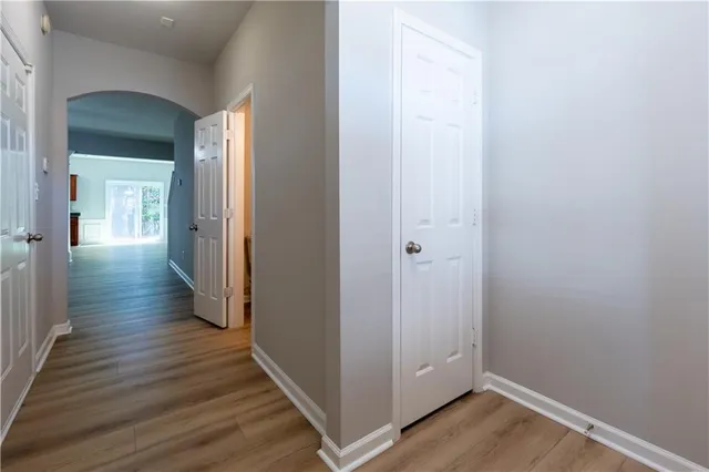 a view of a hallway with wooden floor