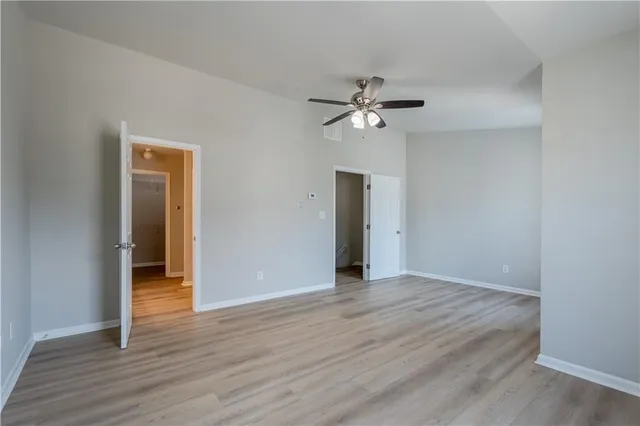 a view of an empty room with wooden floor