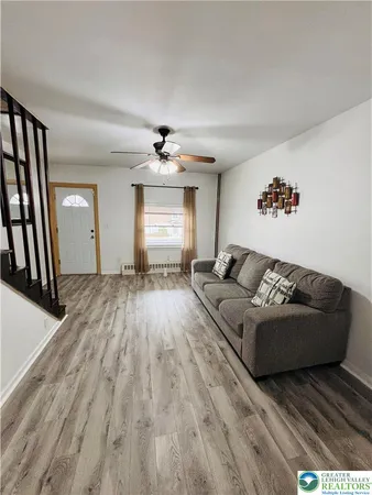a living room with furniture and a flat screen tv