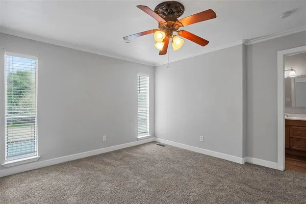 an empty room with closet and a chandelier fan