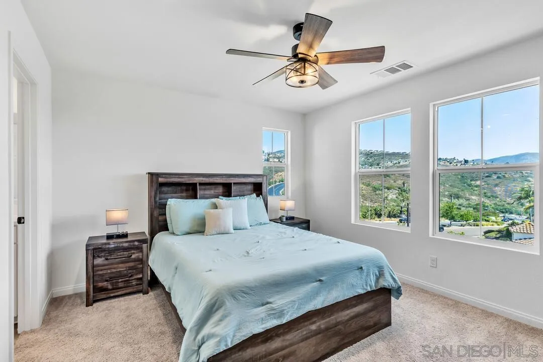 2811 Safflower Street Spring Valley, CA 91977 - Photo 21 of 28 a bedroom with a large bed and a large window