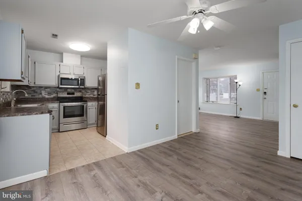 a view of a kitchen with a stove cabinets and wooden floor