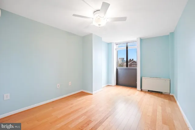 a view of a kitchen with wooden floor and a ceiling fan