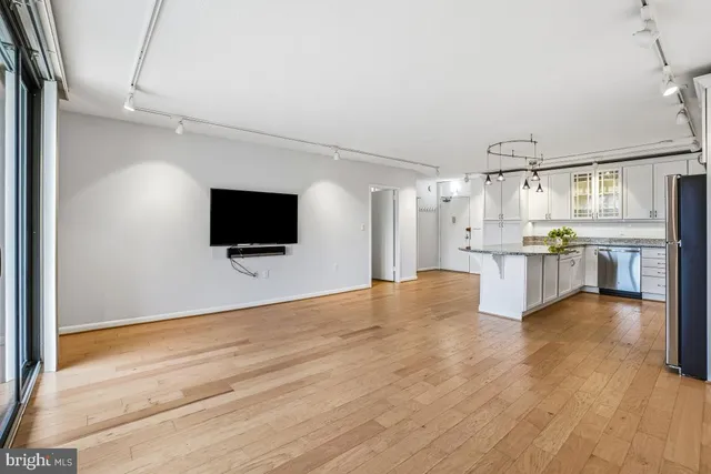 a view of a kitchen with wooden floor and electronic appliances