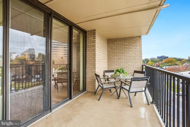 a view of a patio with a table and chairs