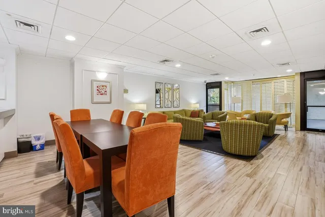 a living room with furniture a ceiling fan and a wooden floor