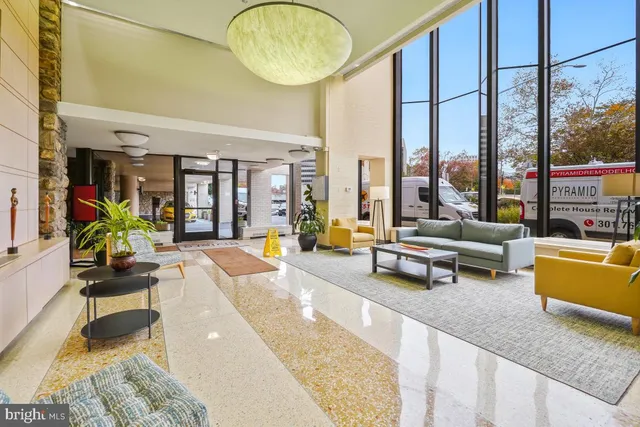 a living room with furniture and a large window