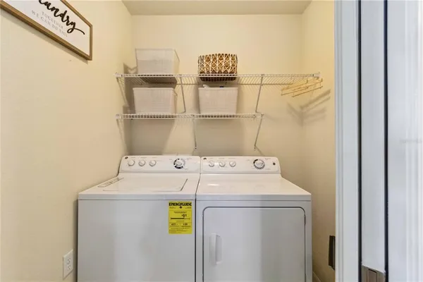 a bedroom with a bed and a flat tv screen on the dresser