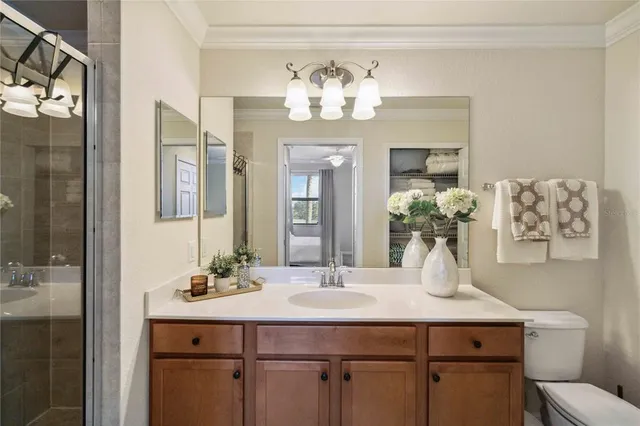 a bathroom with a sink a vanity a lamp and a mirror