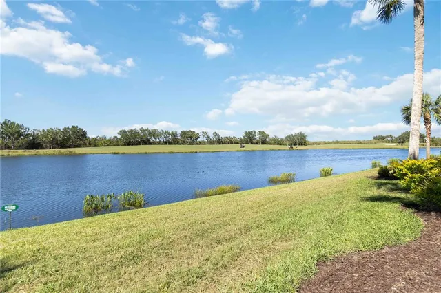 a view of a lake with houses in the back