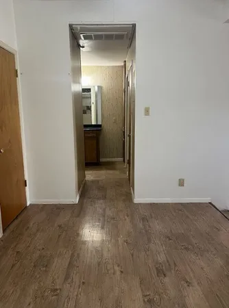 an empty room with wooden floor