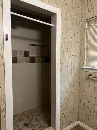 a white toilet sitting next to a shower curtain
