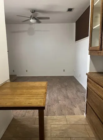 a view of an empty room with furniture and closet