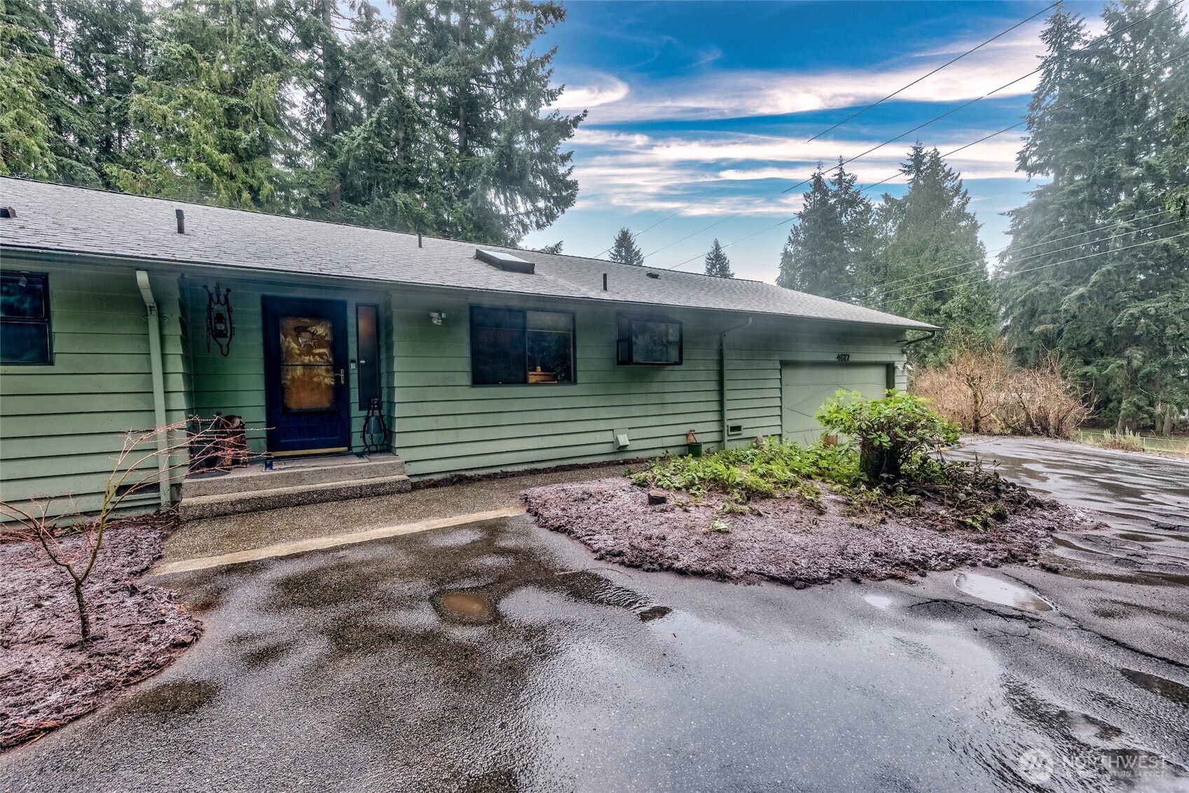 4617 200th Street Southeast Bothell, WA 98012 - Photo 2 of 39 a front view of a house with garden